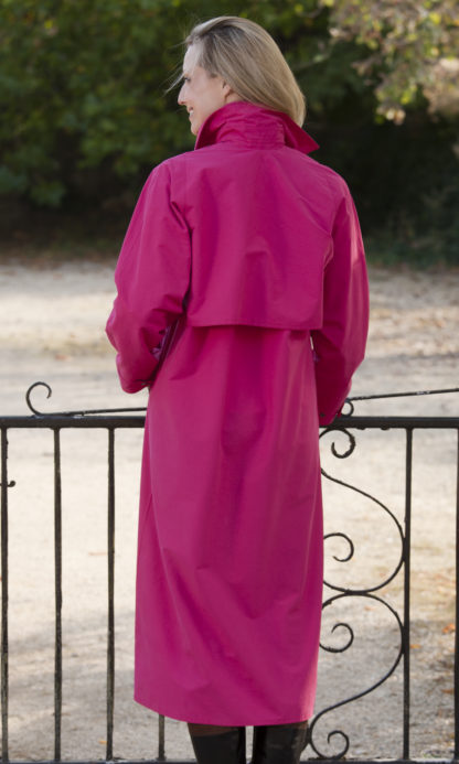 Traditional, long length ladies raincoat in Hot Pink